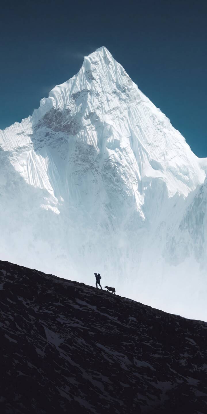 The majestic, snow-capped peak rises sharply against a clear, deep blue sky, creating a breathtaking 4K wallpaper with a tiny silhouetted hiker and dog traversing the dark, rugged foreground – an awe-inspiring wallpaper perfect for your iPhone. | dog snow mountain iphone nature wallpaper mobile 4k wallpaper hd wallpaper epic hiker adventure The majestic, snow-capped peak rises sharply against a clear, deep blue sky, creating a breathtaking 4K wallpaper with a tiny silhouetted hiker and dog traversing the dark, rugged foreground – an awe-inspiring wallpaper perfect for your iPhone.