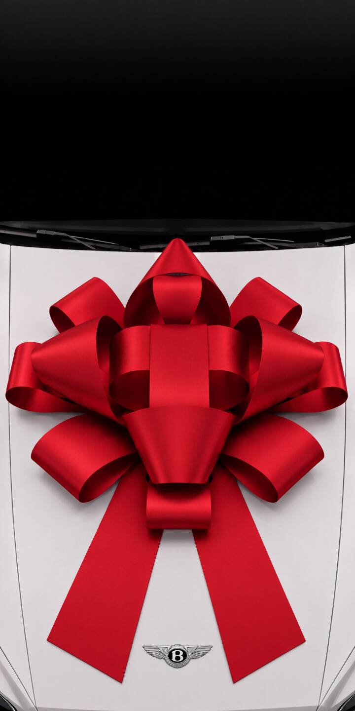 A vibrant red gift bow dominates the pristine white hood of a Bentley, elegantly poised against a stark black background in this stunning 4K wallpaper. This luxurious car wallpaper is a perfect iPhone background for showcasing sophistication and celebration. | aesthetic iphone wallpaper bentley mobile luxury car elegant 4k wallpaper hd wallpaper red bow gift car A vibrant red gift bow dominates the pristine white hood of a Bentley, elegantly poised against a stark black background in this stunning 4K wallpaper. This luxurious car wallpaper is a perfect iPhone background for showcasing sophistication and celebration.