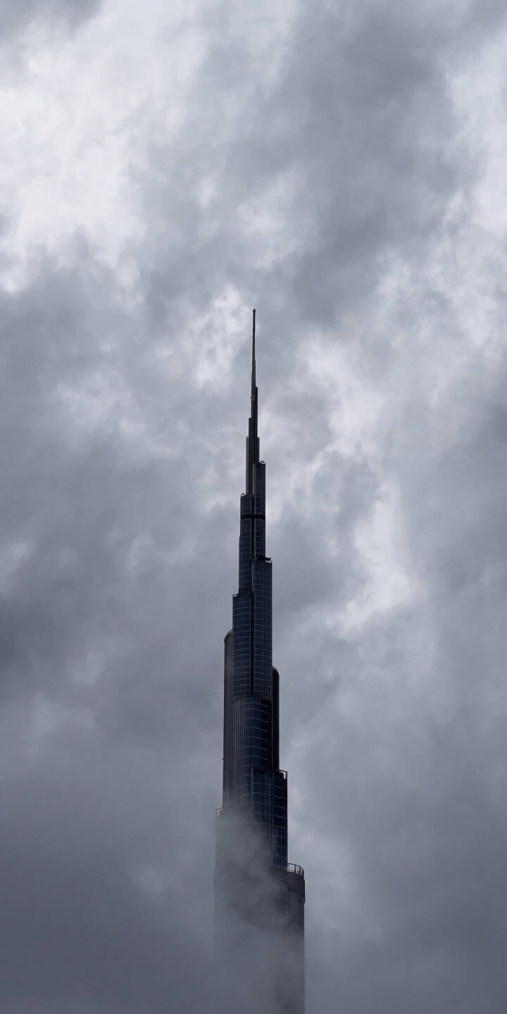 Dense clouds dramatically enshroud the iconic Burj Khalifa, with its magnificent spire piercing through the mist in this striking 4K wallpaper. It's a truly atmospheric iPhone wallpaper for city and architecture enthusiasts. | aesthetic urban skyscraper iphone clouds wallpaper mist mobile 4k wallpaper hd wallpaper dubai burj khalifa Dense clouds dramatically enshroud the iconic Burj Khalifa, with its magnificent spire piercing through the mist in this striking 4K wallpaper. It's a truly atmospheric iPhone wallpaper for city and architecture enthusiasts.