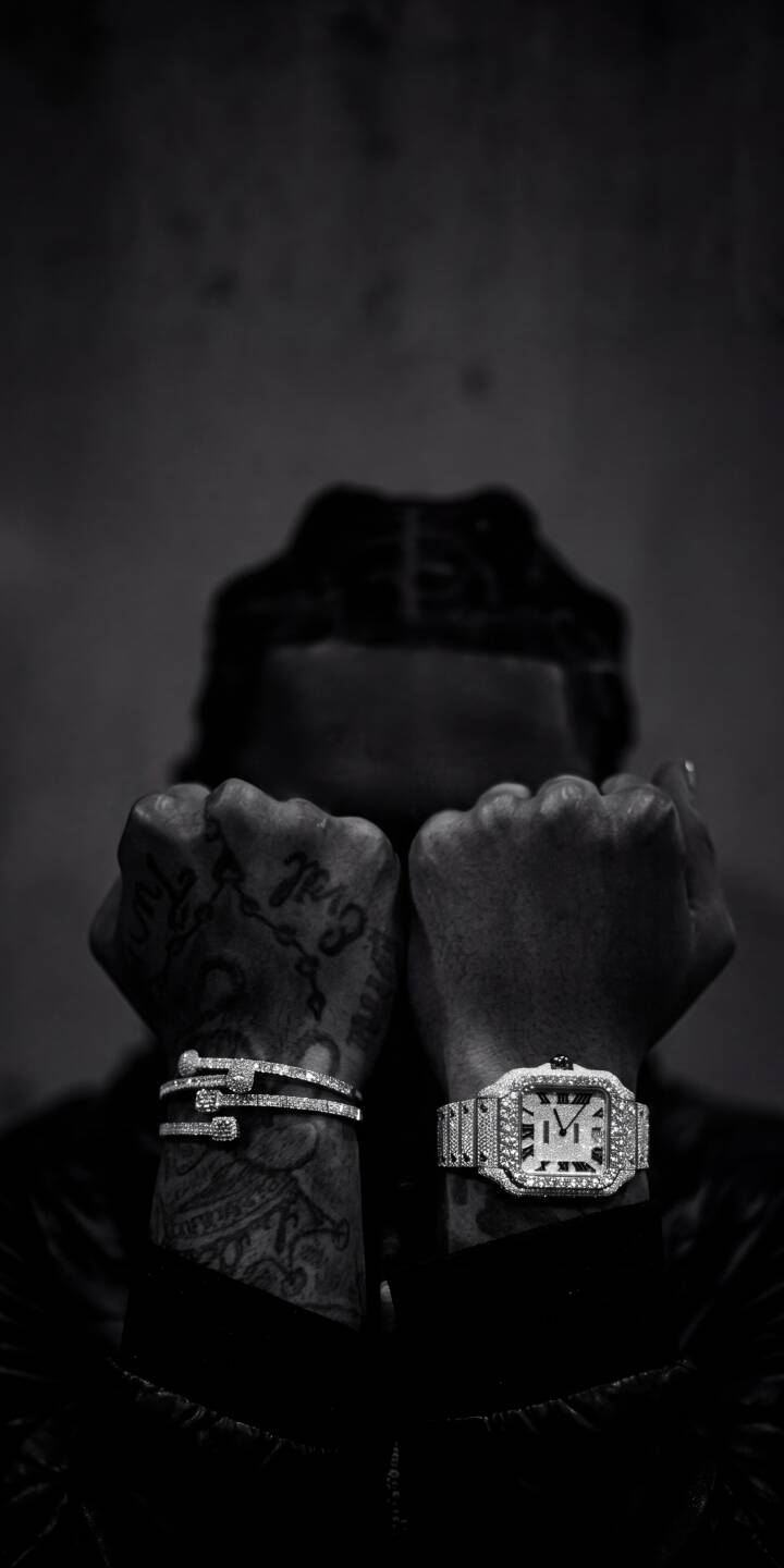 Glistening diamond watch and a matching bracelet adorn tattooed hands, held up to obscure the face in this striking 4K monochrome image, creating a stylish wallpaper for your iPhone. This luxurious wallpaper showcases intricate details and a dark, moody aesthetic. | aesthetic watch tattoo diamond iphone luxury wallpaper mobile 4k wallpaper hd wallpaper jewelry monochrome Glistening diamond watch and a matching bracelet adorn tattooed hands, held up to obscure the face in this striking 4K monochrome image, creating a stylish wallpaper for your iPhone. This luxurious wallpaper showcases intricate details and a dark, moody aesthetic.