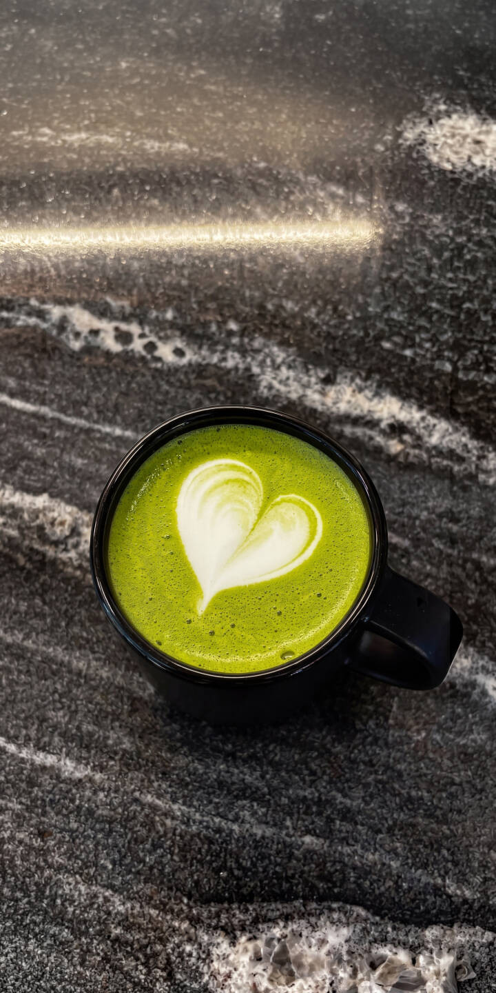 A delicate white heart of latte art stands out against the vibrant green matcha in this stunning 4K wallpaper, set on a dark, patterned granite countertop — a charming wallpaper for iPhone users. | aesthetic green iphone wallpaper coffee mobile matcha 4k wallpaper hd wallpaper latte heart art granite A delicate white heart of latte art stands out against the vibrant green matcha in this stunning 4K wallpaper, set on a dark, patterned granite countertop — a charming wallpaper for iPhone users.