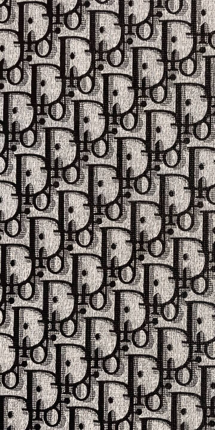 The iconic Dior Oblique monogram pattern creates a sophisticated background in this striking 4K wallpaper. This luxurious textured black and white wallpaper is a perfect download for any fashion-forward iPhone user. | pattern iphone luxury wallpaper fashion black and white dior mobile 4k wallpaper hd wallpaper monogram dior oblique The iconic Dior Oblique monogram pattern creates a sophisticated background in this striking 4K wallpaper. This luxurious textured black and white wallpaper is a perfect download for any fashion-forward iPhone user.