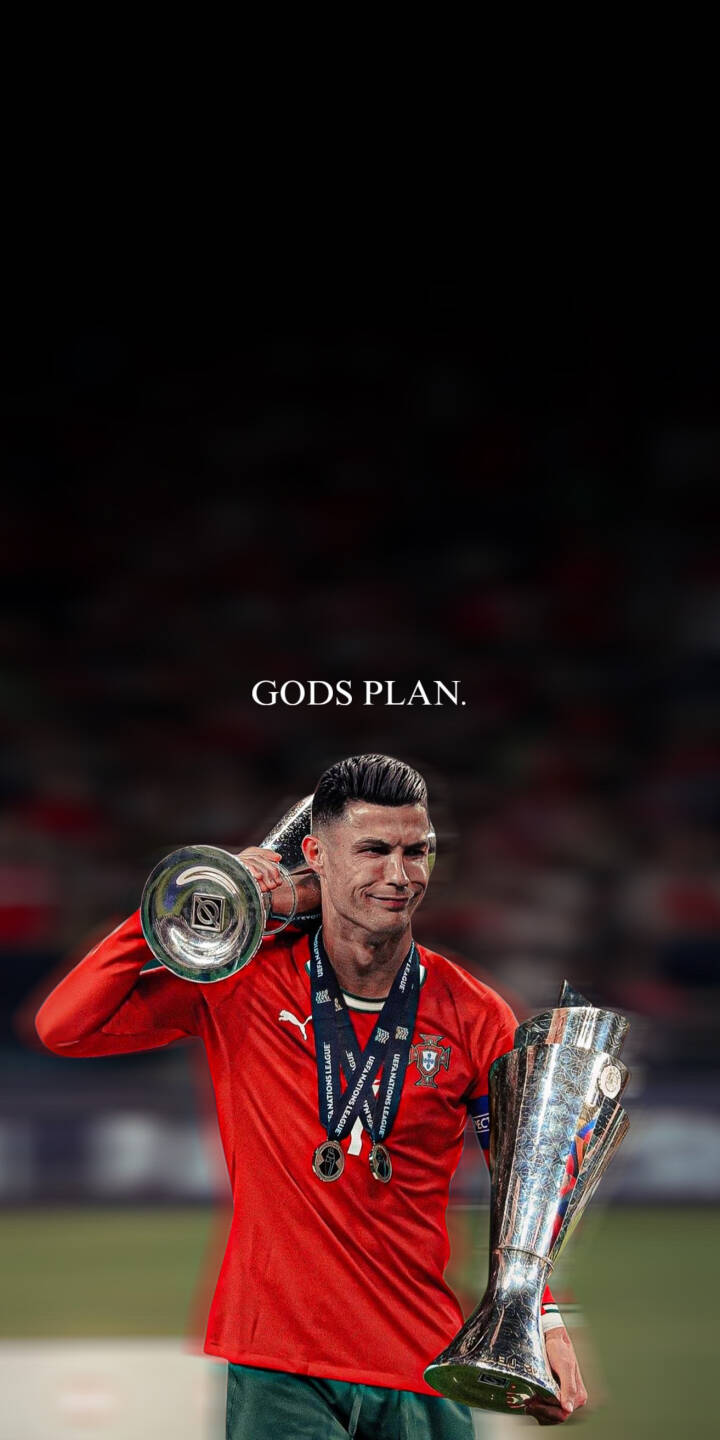 With a triumphant smile, Cristiano Ronaldo proudly holds two gleaming trophies, standing beneath the powerful 'GODS PLAN.' text in this iconic 4K wallpaper, making it an essential football wallpaper for any iPhone. | football trophy iphone ronaldo wallpaper cr7 cristiano ronaldo mobile 4k wallpaper hd wallpaper victory gods plan With a triumphant smile, Cristiano Ronaldo proudly holds two gleaming trophies, standing beneath the powerful 'GODS PLAN.' text in this iconic 4K wallpaper, making it an essential football wallpaper for any iPhone.