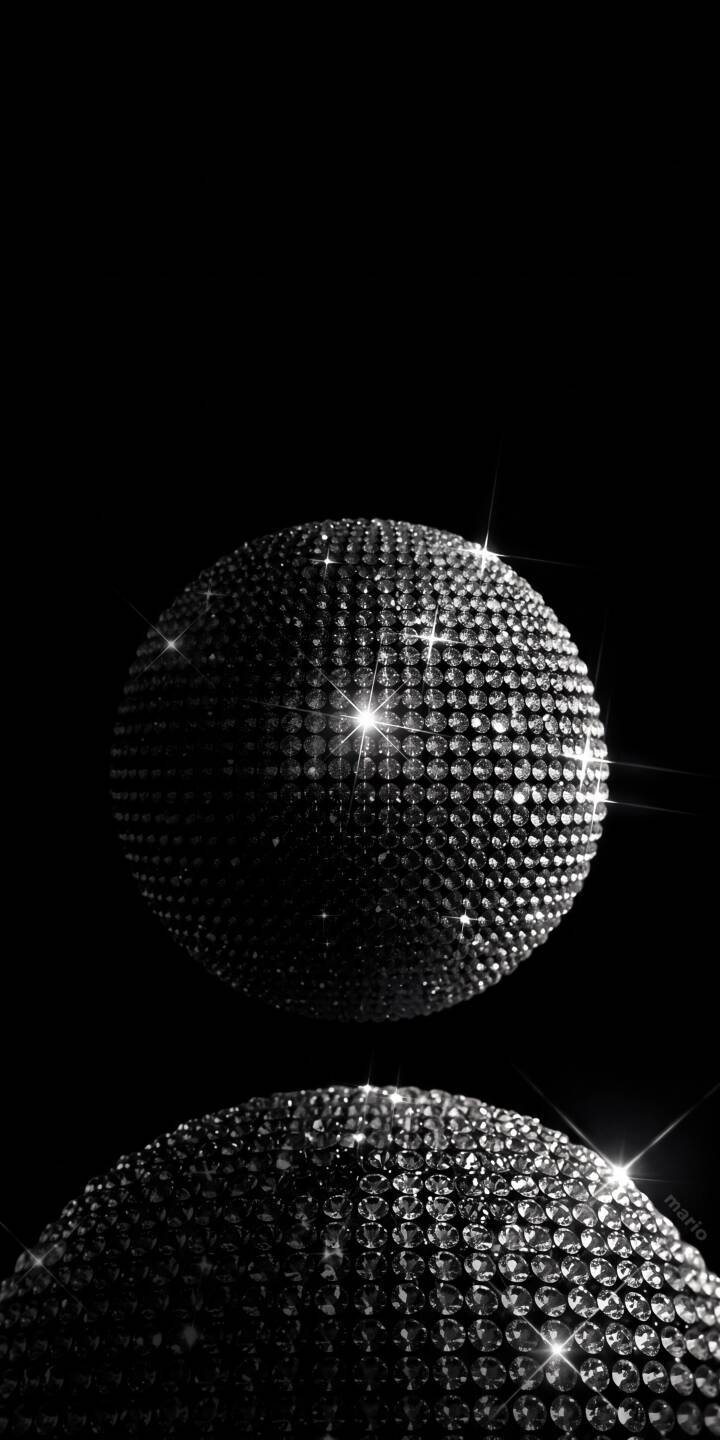 Gleaming silver facets cover a perfectly spherical orb, casting brilliant star-like sparkles against the deep black background in this mesmerizing 4K wallpaper. This opulent wallpaper is a perfect choice for your iPhone, showcasing an intricate reflection below the main crystal-studded object. | aesthetic reflection disco ball iphone shiny wallpaper black background sparkling mobile crystal ball 4k wallpaper hd wallpaper Gleaming silver facets cover a perfectly spherical orb, casting brilliant star-like sparkles against the deep black background in this mesmerizing 4K wallpaper. This opulent wallpaper is a perfect choice for your iPhone, showcasing an intricate reflection below the main crystal-studded object.