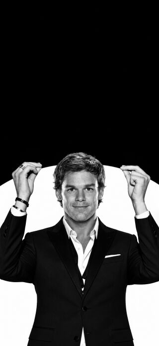 This stunning black and white 4K wallpaper captures Michael C. Hall in an elegant black suit, creating a dynamic double wallpaper effect across your iPhone's lock and home screens. It's an iconic portrait featuring his subtle smile, making it a perfect mobile wallpaper choice.