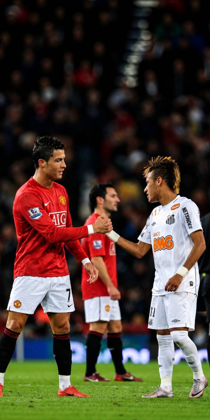 Cristiano Ronaldo in his iconic red Manchester United jersey and Neymar Jr. in white Santos FC shake hands, capturing an iconic moment of football sportsmanship in this vibrant 4K wallpaper. This unique wallpaper for iPhone fans showcases two legendary players meeting on the pitch. | football iphone soccer wallpaper cristiano ronaldo legends mobile manchester united santos fc 4k wallpaper hd wallpaper neymar jr Cristiano Ronaldo in his iconic red Manchester United jersey and Neymar Jr. in white Santos FC shake hands, capturing an iconic moment of football sportsmanship in this vibrant 4K wallpaper. This unique wallpaper for iPhone fans showcases two legendary players meeting on the pitch.
