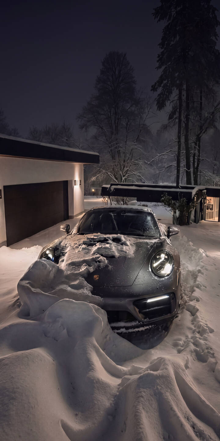 Deep snow drifts frame the sleek silver Porsche as its bright headlights pierce the winter night in this stunning 4K wallpaper, making it a perfect automotive wallpaper for iPhone. | aesthetic sports car night snow winter iphone porsche wallpaper mobile 4k wallpaper hd wallpaper automotive Deep snow drifts frame the sleek silver Porsche as its bright headlights pierce the winter night in this stunning 4K wallpaper, making it a perfect automotive wallpaper for iPhone.