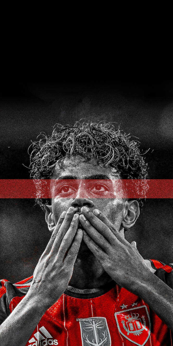 A striking selective color image captures a soccer player, hands over his mouth, with an intense gaze framed by a red bar, making this a powerful 4K wallpaper. This emotional red and black wallpaper is perfect for any iPhone user who loves sports. | sports football aesthetic athlete iphone wallpaper soccer player mobile emotional 4k wallpaper hd wallpaper red and black A striking selective color image captures a soccer player, hands over his mouth, with an intense gaze framed by a red bar, making this a powerful 4K wallpaper. This emotional red and black wallpaper is perfect for any iPhone user who loves sports.