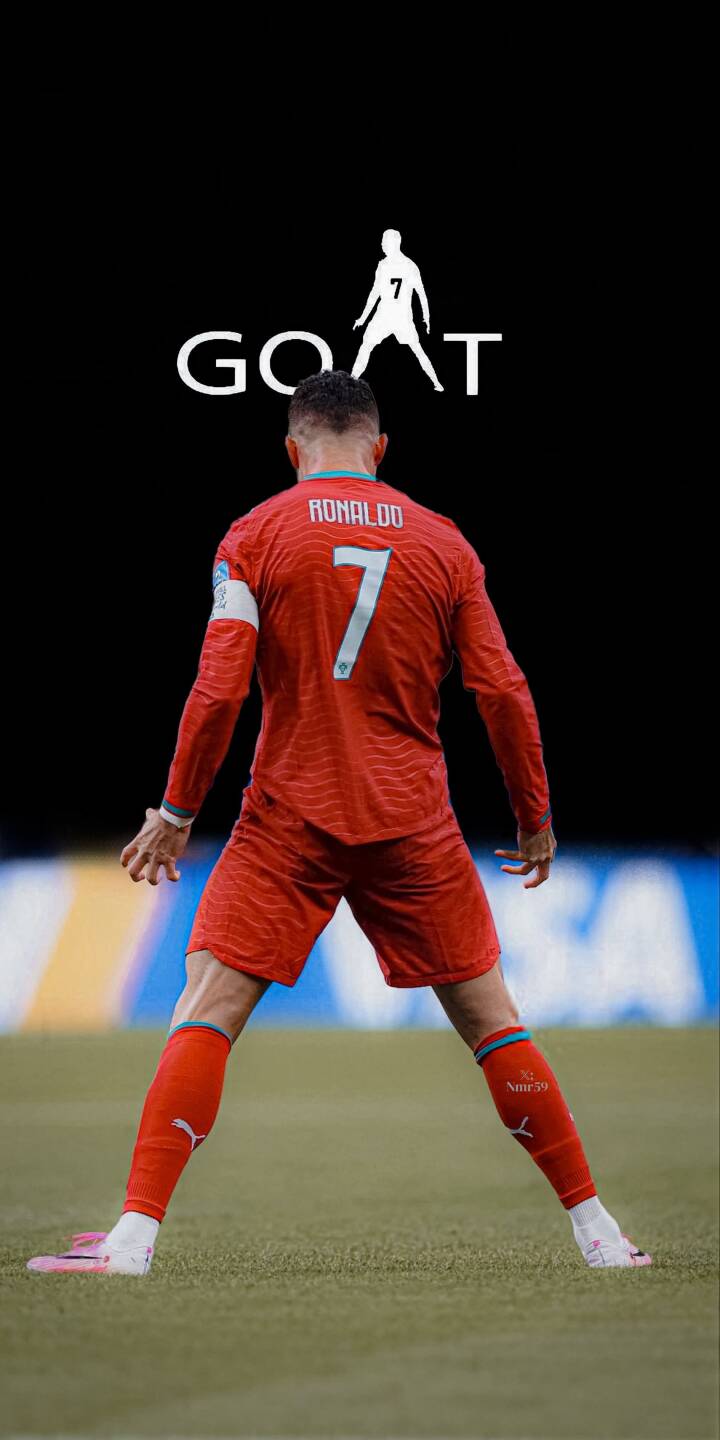 The iconic number 7 shines brightly on Cristiano Ronaldo's vibrant red jersey, captured from behind on a lush green field in this dynamic 4K wallpaper. Above him, a crisp 'GOAT' text with a player silhouette completes this must-have wallpaper for iPhone. | football athlete iphone soccer wallpaper goat cr7 cristiano ronaldo mobile 4k wallpaper hd wallpaper red jersey The iconic number 7 shines brightly on Cristiano Ronaldo's vibrant red jersey, captured from behind on a lush green field in this dynamic 4K wallpaper. Above him, a crisp 'GOAT' text with a player silhouette completes this must-have wallpaper for iPhone.