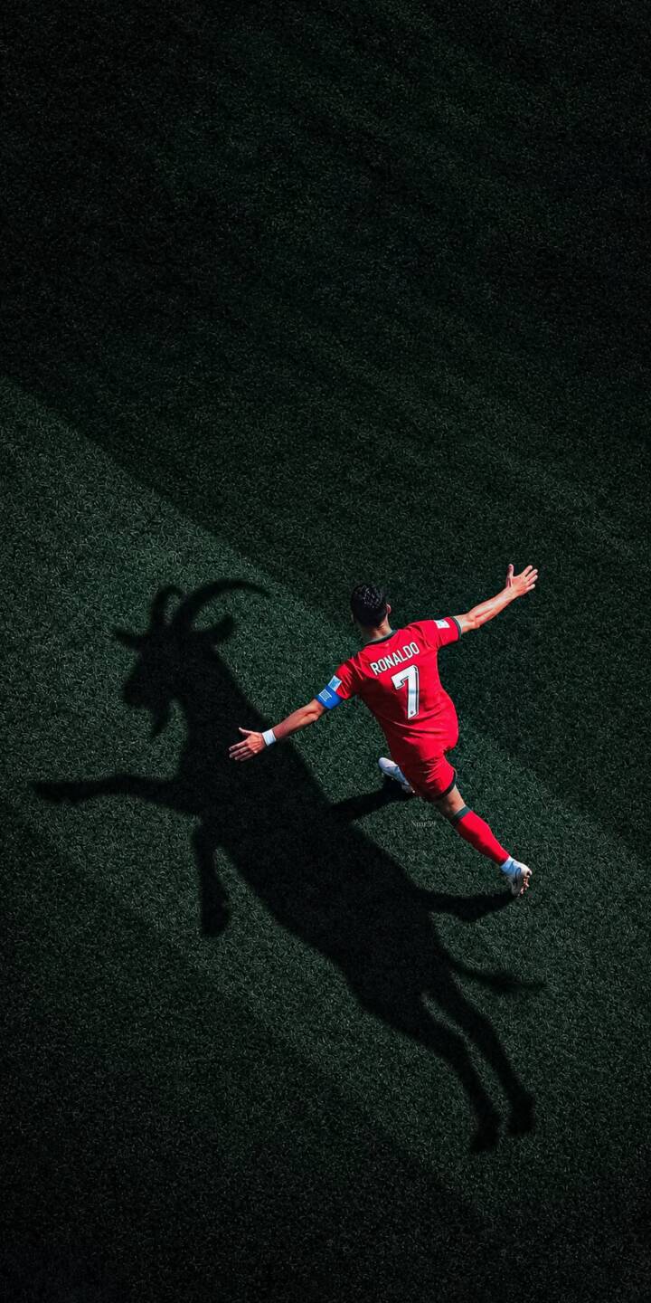 Cristiano Ronaldo's iconic celebration casts a powerful goat-shaped shadow across the vibrant green pitch in this stunning 4K wallpaper. This dynamic wallpaper, featuring his red jersey and outstretched arms, is an essential download for iPhone fans. | football celebration iphone ronaldo soccer wallpaper cr7 cristiano ronaldo mobile 4k wallpaper hd wallpaper goat shadow Cristiano Ronaldo's iconic celebration casts a powerful goat-shaped shadow across the vibrant green pitch in this stunning 4K wallpaper. This dynamic wallpaper, featuring his red jersey and outstretched arms, is an essential download for iPhone fans.