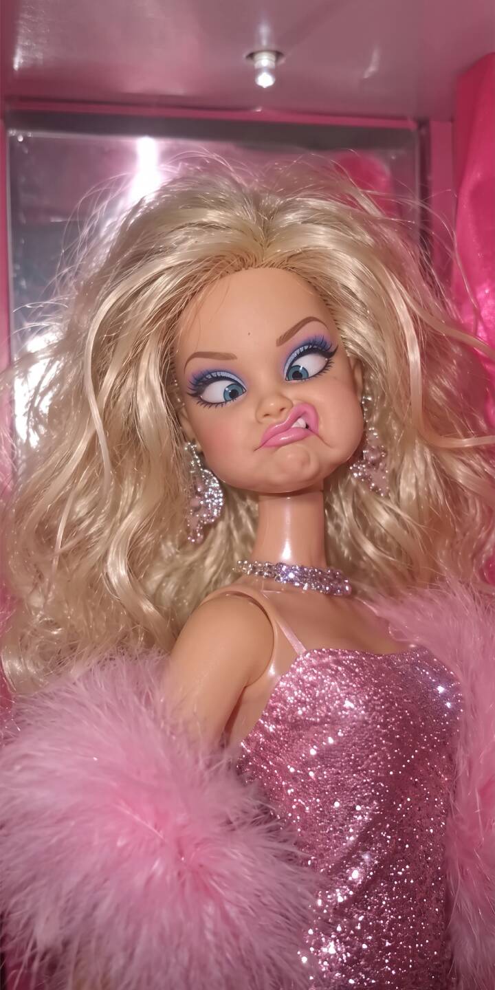 This glamorous doll's hilariously cross-eyed and tongue-out expression in a sparkly pink dress makes for an unforgettably fun 4K wallpaper; a vibrant and playful wallpaper perfect for your iPhone screen. | pink funny toy doll iphone silly wallpaper mobile 4k wallpaper hd wallpaper glitter glamorous This glamorous doll's hilariously cross-eyed and tongue-out expression in a sparkly pink dress makes for an unforgettably fun 4K wallpaper; a vibrant and playful wallpaper perfect for your iPhone screen.