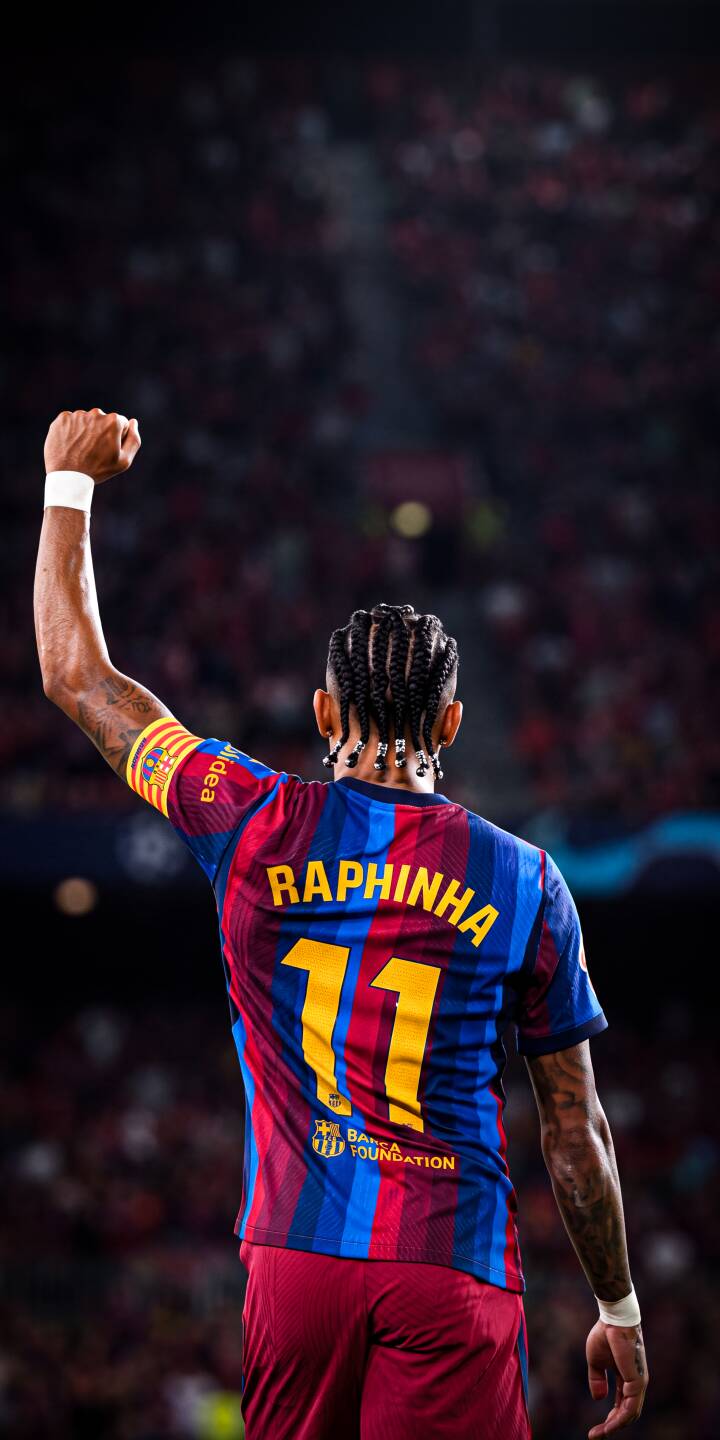 Raphinha's raised fist salutes the adoring crowd, his blue and red FC Barcelona jersey prominently displaying 'RAPHINHA 11' in this vibrant 4K wallpaper; a must-have wallpaper for iPhone fans of the iconic football star. | sports football celebration iphone soccer barcelona wallpaper raphinha fc barcelona mobile 4k wallpaper hd wallpaper Raphinha's raised fist salutes the adoring crowd, his blue and red FC Barcelona jersey prominently displaying 'RAPHINHA 11' in this vibrant 4K wallpaper; a must-have wallpaper for iPhone fans of the iconic football star.