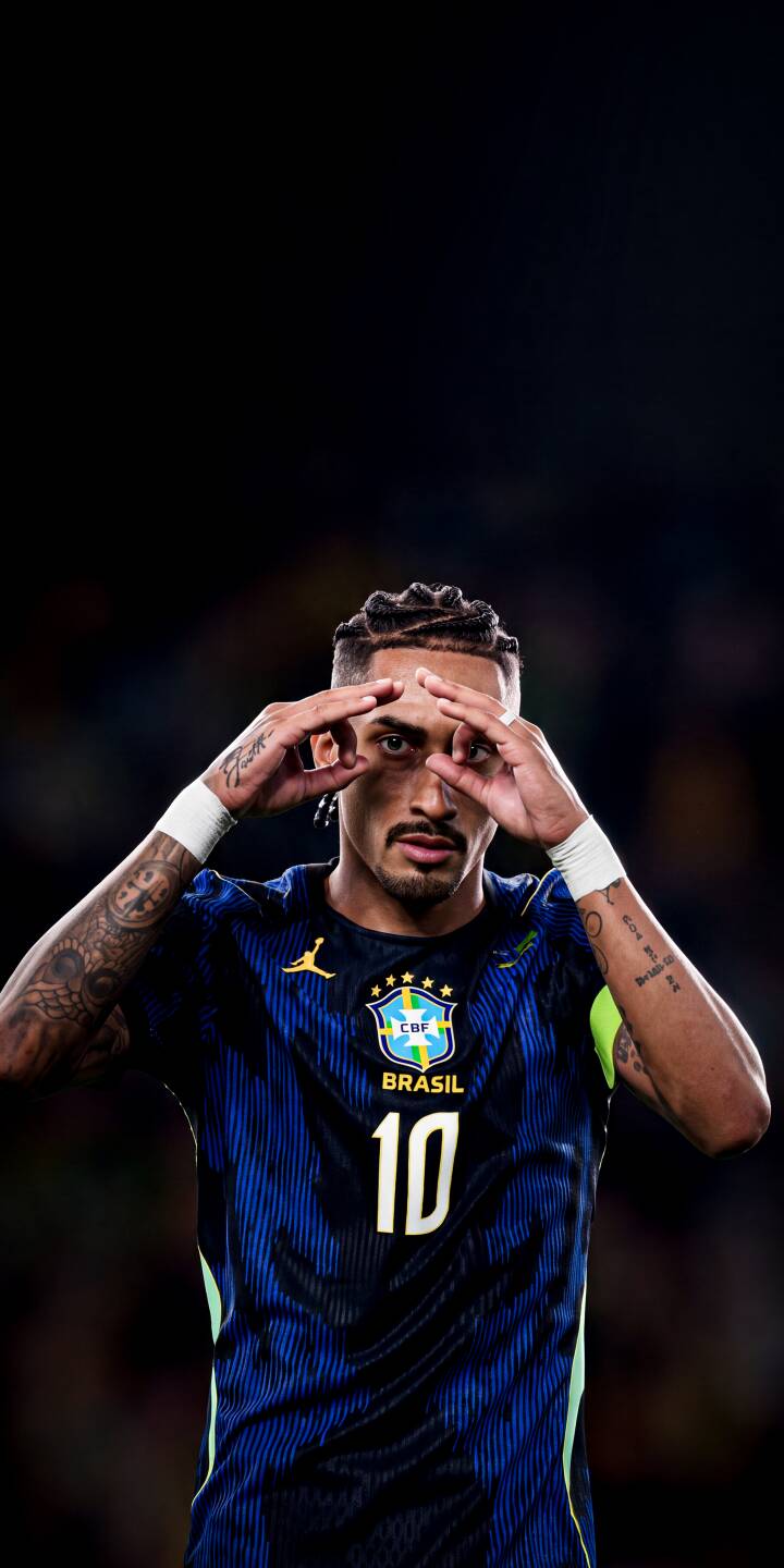 Gabriel Jesus frames his eyes with his hands in an iconic celebration, proudly wearing the dark blue Brazil number 10 jersey. This compelling 4K wallpaper is perfect for your iPhone, making it a standout football wallpaper. | football athlete celebration iphone soccer wallpaper brazil jesus mobile 4k wallpaper hd wallpaper gabriel jesus Gabriel Jesus frames his eyes with his hands in an iconic celebration, proudly wearing the dark blue Brazil number 10 jersey. This compelling 4K wallpaper is perfect for your iPhone, making it a standout football wallpaper.