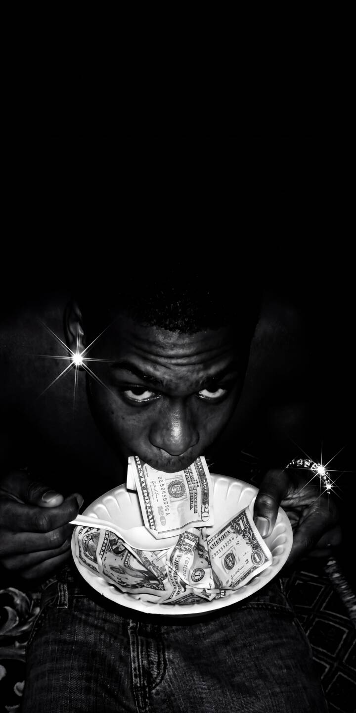 An intense gaze pierces from the darkness as a figure consumes dollar bills from a paper plate in this stark black and white 4K wallpaper. This unique wallpaper captures a gritty aesthetic, making it a compelling choice for your iPhone lock screen. | cash money greed iphone wallpaper black and white dollars mobile 4k wallpaper hd wallpaper dark aesthetic gritty An intense gaze pierces from the darkness as a figure consumes dollar bills from a paper plate in this stark black and white 4K wallpaper. This unique wallpaper captures a gritty aesthetic, making it a compelling choice for your iPhone lock screen.