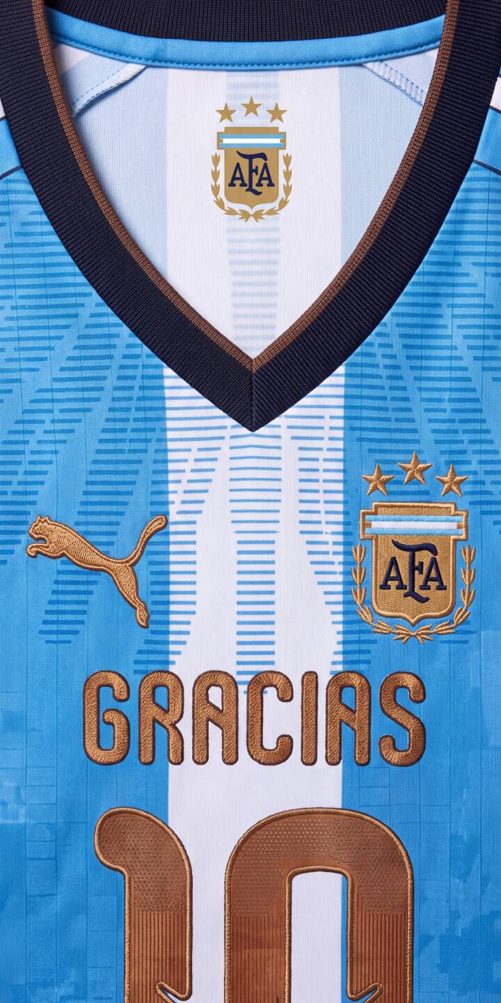 Intricate gold stitching reveals 'GRACIAS' and the iconic number '10' on this stunning Argentina national team jersey in a vibrant 4K wallpaper. This dynamic wallpaper, featuring the AFA crest with three stars, is perfect for any iPhone to celebrate football passion. | gold iphone messi argentina soccer wallpaper jersey mobile 4k wallpaper hd wallpaper number 10 afa Intricate gold stitching reveals 'GRACIAS' and the iconic number '10' on this stunning Argentina national team jersey in a vibrant 4K wallpaper. This dynamic wallpaper, featuring the AFA crest with three stars, is perfect for any iPhone to celebrate football passion.