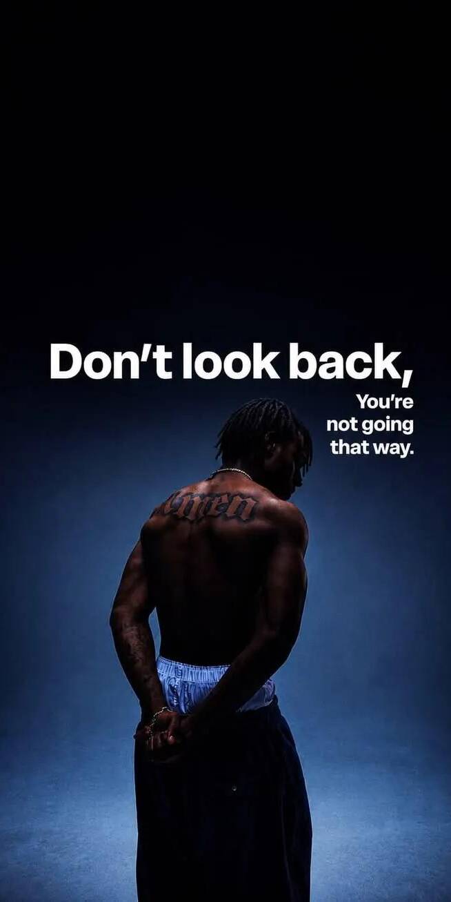 The powerful motivational quote 'Don't look back, You're not going that way' dominates this striking 4K wallpaper, featuring a man with a distinctive 'OVYEN' tattoo visible on his muscled back, bathed in moody blue lighting. This inspiring wallpaper is perfect for any iPhone. | motivational The powerful motivational quote 'Don't look back, You're not going that way' dominates this striking 4K wallpaper, featuring a man with a distinctive 'OVYEN' tattoo visible on his muscled back, bathed in moody blue lighting. This inspiring wallpaper is perfect for any iPhone.