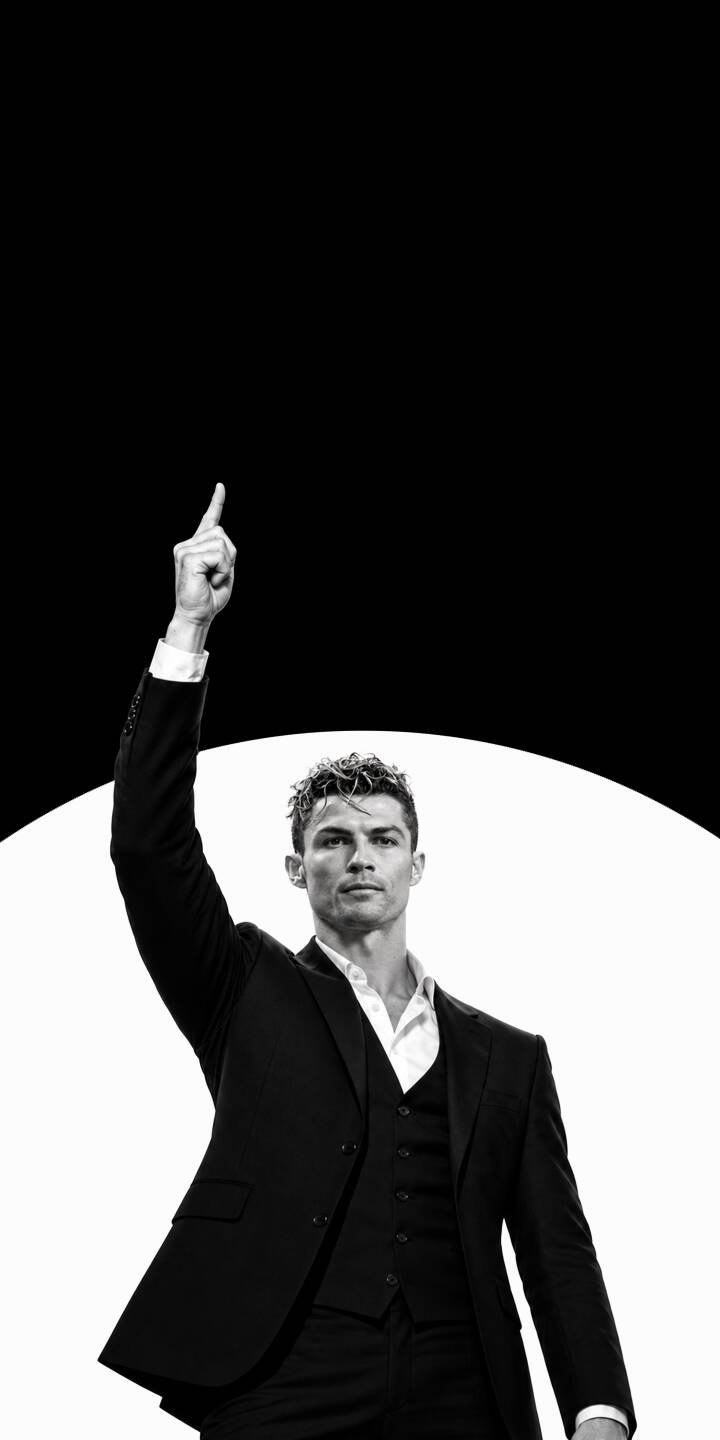 Cristiano Ronaldo's iconic upward-pointing gesture dominates this high-contrast 4K wallpaper, showcasing him in a sharp black suit against a stark black and white background. This powerful image makes for a sophisticated wallpaper on your iPhone. | suit athlete iphone ronaldo wallpaper cr7 black and white cristiano ronaldo mobile 4k wallpaper hd wallpaper iconic Cristiano Ronaldo's iconic upward-pointing gesture dominates this high-contrast 4K wallpaper, showcasing him in a sharp black suit against a stark black and white background. This powerful image makes for a sophisticated wallpaper on your iPhone.