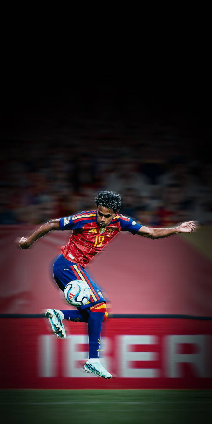 A youthful football player in a vibrant red, yellow, and blue national team kit expertly controls the ball in mid-air, creating a dynamic 4K wallpaper. This energetic action shot is a perfect wallpaper for iPhone, capturing the thrill of the game with incredible detail. | sports stadium iphone dynamic wallpaper soccer player action mobile footballer 4k wallpaper hd wallpaper spain football A youthful football player in a vibrant red, yellow, and blue national team kit expertly controls the ball in mid-air, creating a dynamic 4K wallpaper. This energetic action shot is a perfect wallpaper for iPhone, capturing the thrill of the game with incredible detail.