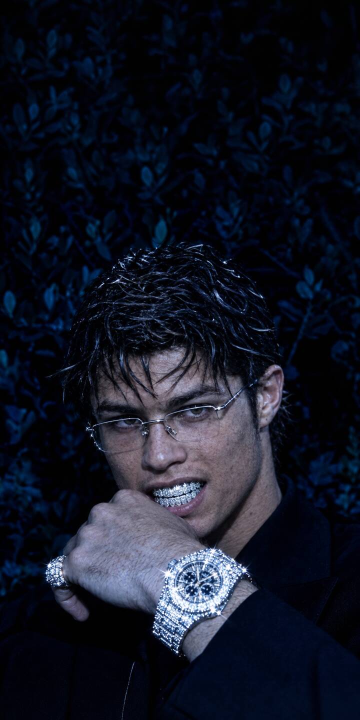 Diamond grillz flash brightly as Cristiano Ronaldo glares intensely from beneath his diamond-studded glasses in this stunning 4K wallpaper. This luxurious wallpaper, featuring his sparkling watch, is a must-have for your iPhone. | diamond iphone ronaldo luxury wallpaper cr7 cristiano ronaldo grillz mobile 4k wallpaper hd wallpaper bling Diamond grillz flash brightly as Cristiano Ronaldo glares intensely from beneath his diamond-studded glasses in this stunning 4K wallpaper. This luxurious wallpaper, featuring his sparkling watch, is a must-have for your iPhone.