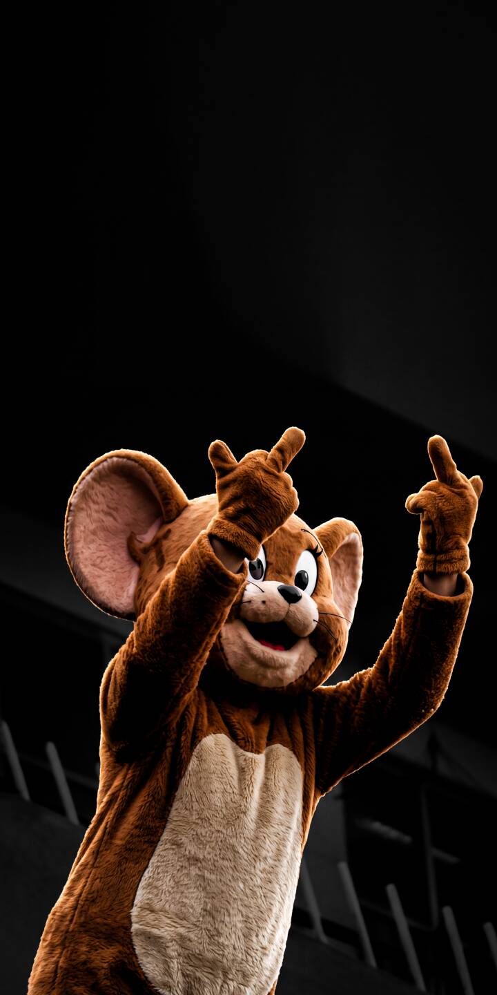 A Jerry mouse mascot, wearing its classic brown fur, makes a bold and irreverent gesture with both hands while sporting a mischievous grin in this eye-catching 4K wallpaper. This dynamic and humorous image makes a perfect unique statement wallpaper for iPhone. | cartoon funny iphone tom and jerry jerry wallpaper rude mobile 4k wallpaper hd wallpaper mascot jerry mouse A Jerry mouse mascot, wearing its classic brown fur, makes a bold and irreverent gesture with both hands while sporting a mischievous grin in this eye-catching 4K wallpaper. This dynamic and humorous image makes a perfect unique statement wallpaper for iPhone.