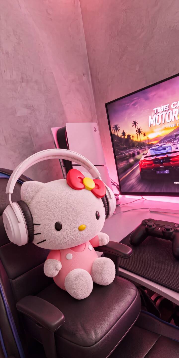 A cute Hello Kitty plushie, donned in white headphones and a pink outfit, sits in a gaming chair amidst a vibrant, pink-lit 4K gaming setup, making for an adorable wallpaper. This charming scene, complete with a PS5 and racing game on screen, is a perfect iPhone wallpaper for fans. | pink aesthetic cute hello kitty iphone gaming wallpaper mobile 4k wallpaper hd wallpaper sanrio plushie A cute Hello Kitty plushie, donned in white headphones and a pink outfit, sits in a gaming chair amidst a vibrant, pink-lit 4K gaming setup, making for an adorable wallpaper. This charming scene, complete with a PS5 and racing game on screen, is a perfect iPhone wallpaper for fans.