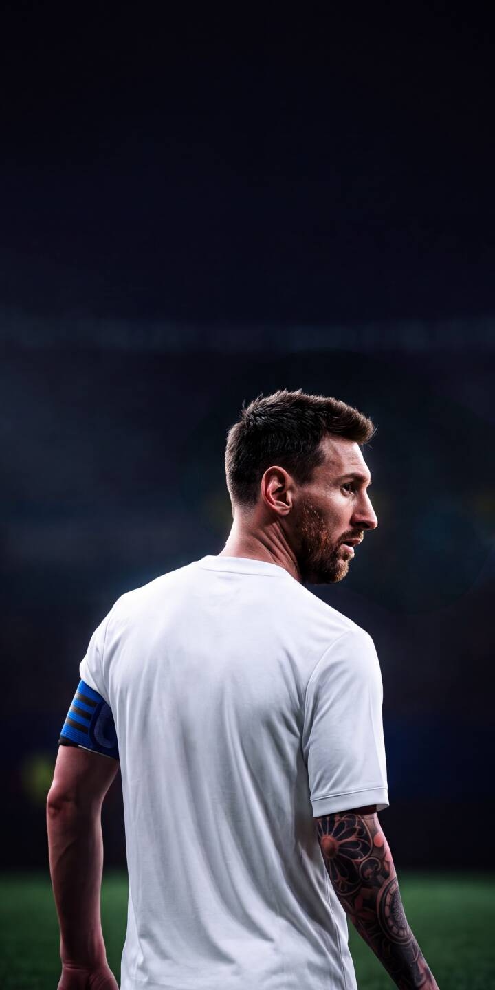 Lionel Messi, wearing a crisp white t-shirt, looks intently over his shoulder on the dark stadium pitch in this powerful 4K wallpaper. His iconic profile and detailed arm tattoo make this a striking mobile wallpaper for any iPhone, capturing a moment of focus. | football stadium tattoo athlete iphone messi soccer wallpaper lionel messi mobile 4k wallpaper hd wallpaper Lionel Messi, wearing a crisp white t-shirt, looks intently over his shoulder on the dark stadium pitch in this powerful 4K wallpaper. His iconic profile and detailed arm tattoo make this a striking mobile wallpaper for any iPhone, capturing a moment of focus.