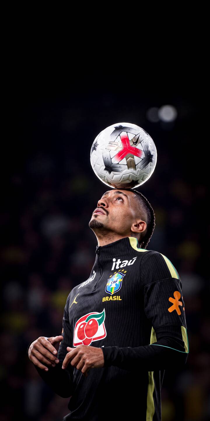The focused Brazilian player expertly balances a soccer ball on his head, showcasing impressive ball control in this striking 4K wallpaper. This dynamic wallpaper is perfect for iPhone fans of football. | sports football athlete focus iphone soccer wallpaper mobile 4k wallpaper hd wallpaper brazilian player ball control The focused Brazilian player expertly balances a soccer ball on his head, showcasing impressive ball control in this striking 4K wallpaper. This dynamic wallpaper is perfect for iPhone fans of football.