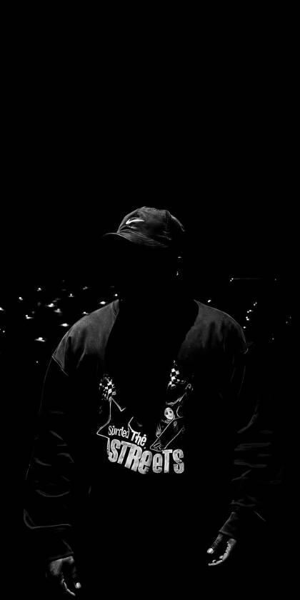 The subtle gleam of a Nike cap barely breaks the deep shadows obscuring a figure wearing a 'Sorted The STREETs' sweatshirt, making this dark urban 4K wallpaper a compelling choice for iPhone customization. | dark The subtle gleam of a Nike cap barely breaks the deep shadows obscuring a figure wearing a 'Sorted The STREETs' sweatshirt, making this dark urban 4K wallpaper a compelling choice for iPhone customization.