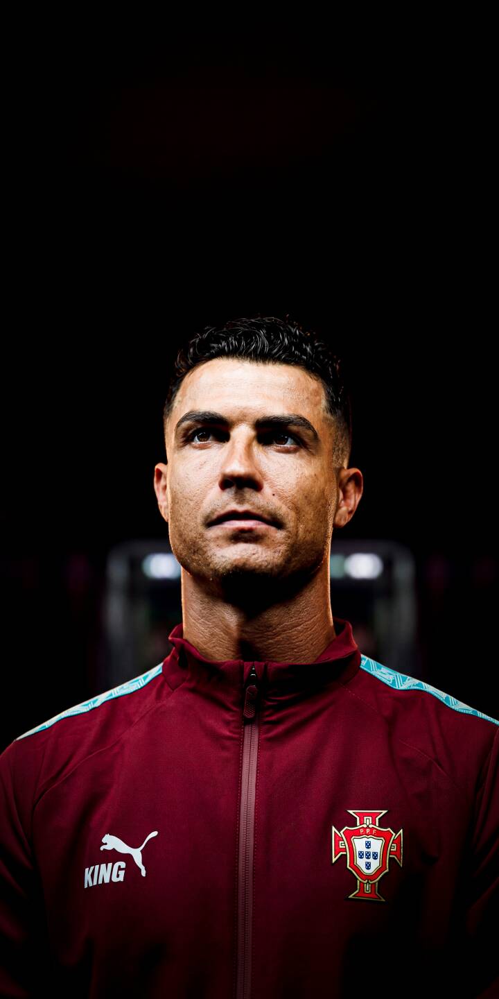 The vivid red of Cristiano Ronaldo's Portugal tracksuit, emblazoned with the national crest and Puma logo, stands out against a dramatic dark background in this powerful 4K wallpaper, a perfect choice for iPhone users seeking a dynamic display. | football dark athlete iphone ronaldo soccer wallpaper portugal cristiano ronaldo mobile 4k wallpaper hd wallpaper The vivid red of Cristiano Ronaldo's Portugal tracksuit, emblazoned with the national crest and Puma logo, stands out against a dramatic dark background in this powerful 4K wallpaper, a perfect choice for iPhone users seeking a dynamic display.