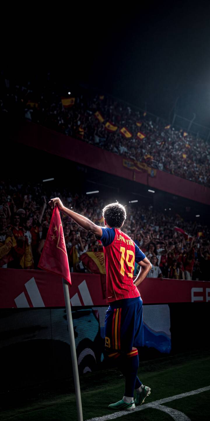 Bright stadium lights create a dazzling halo around Aymeric Laporte's hair as he triumphantly holds the red corner flag, number 19 visible on his Spain jersey, in this captivating 4K wallpaper. This dynamic wallpaper captures the celebratory atmosphere perfect for your iPhone screen. | sports stadium celebration iphone soccer wallpaper mobile 4k wallpaper hd wallpaper spain football laporte aymeric laporte Bright stadium lights create a dazzling halo around Aymeric Laporte's hair as he triumphantly holds the red corner flag, number 19 visible on his Spain jersey, in this captivating 4K wallpaper. This dynamic wallpaper captures the celebratory atmosphere perfect for your iPhone screen.