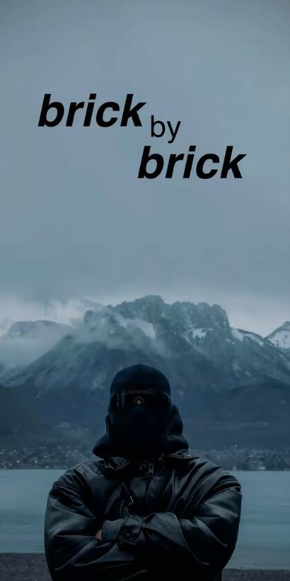 Striking "brick by brick" text floats above a mysterious, balaclava-clad figure set against a vast, misty mountain and lake backdrop in this inspiring 4K wallpaper for iPhone. This unique aesthetic wallpaper captures a sense of determination and cool, perfect for personalizing your device. | motivational Striking "brick by brick" text floats above a mysterious, balaclava-clad figure set against a vast, misty mountain and lake backdrop in this inspiring 4K wallpaper for iPhone. This unique aesthetic wallpaper captures a sense of determination and cool, perfect for personalizing your device.
