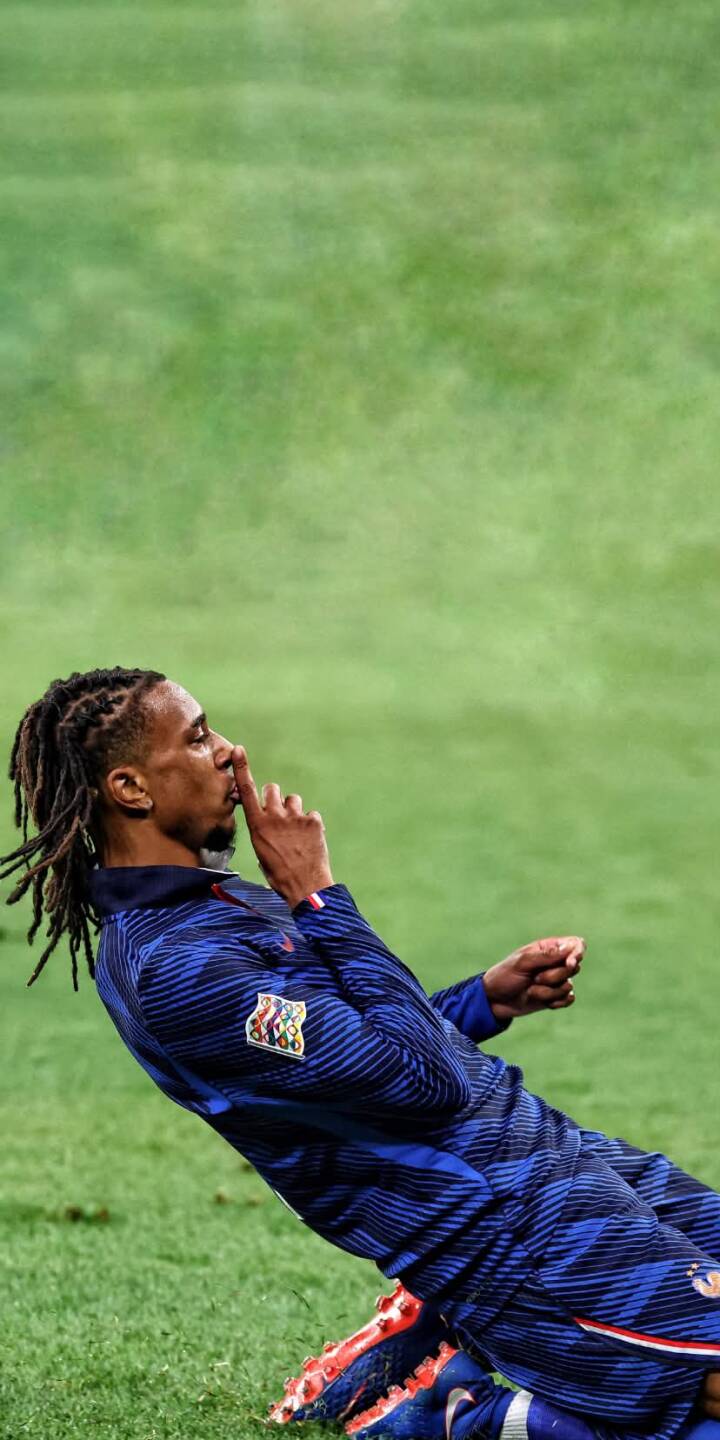 The soccer player's distinct shush gesture, with a finger pressed to his lips, takes center stage on a vibrant green field in this dynamic 4K wallpaper. This captivating moment, showcasing his blue striped jersey and dreadlocks, makes for an epic phone wallpaper on any iPhone. | football player athlete celebration iphone soccer wallpaper mobile 4k wallpaper hd wallpaper dreadlocks shush gesture The soccer player's distinct shush gesture, with a finger pressed to his lips, takes center stage on a vibrant green field in this dynamic 4K wallpaper. This captivating moment, showcasing his blue striped jersey and dreadlocks, makes for an epic phone wallpaper on any iPhone.