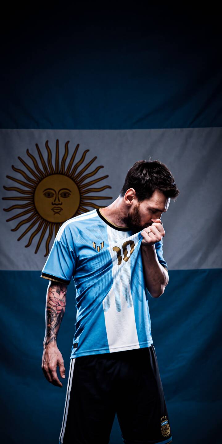 Lionel Messi reverently kisses his #10 Argentina jersey badge, with the national flag proudly displayed behind him, creating an iconic 4K wallpaper. This stunning wallpaper, featuring Messi's intricate arm tattoo, is perfect for any iPhone to celebrate the football legend. | sports football iphone messi argentina soccer wallpaper lionel messi mobile 4k wallpaper hd wallpaper argentine Lionel Messi reverently kisses his #10 Argentina jersey badge, with the national flag proudly displayed behind him, creating an iconic 4K wallpaper. This stunning wallpaper, featuring Messi's intricate arm tattoo, is perfect for any iPhone to celebrate the football legend.