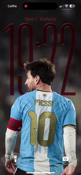 Lionel Messi's iconic gold 'MESSI' and number '10' gleam prominently on his sky blue and white Argentina jersey. This captivating 4K wallpaper, featuring his distinctive bearded profile and a red armband, makes a perfect mobile wallpaper for iPhone to celebrate the legendary footballer.