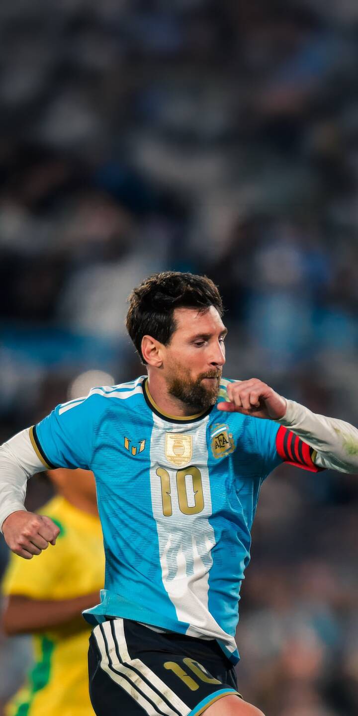 Lionel Messi proudly wears his iconic sky blue and white Argentina number 10 jersey in this electrifying 4K wallpaper, making it a powerful wallpaper for any iPhone. His focused expression captures the intensity of the game amidst the blurred stadium lights. | sports football iphone messi argentina soccer wallpaper lionel messi mobile 4k wallpaper hd wallpaper Lionel Messi proudly wears his iconic sky blue and white Argentina number 10 jersey in this electrifying 4K wallpaper, making it a powerful wallpaper for any iPhone. His focused expression captures the intensity of the game amidst the blurred stadium lights.