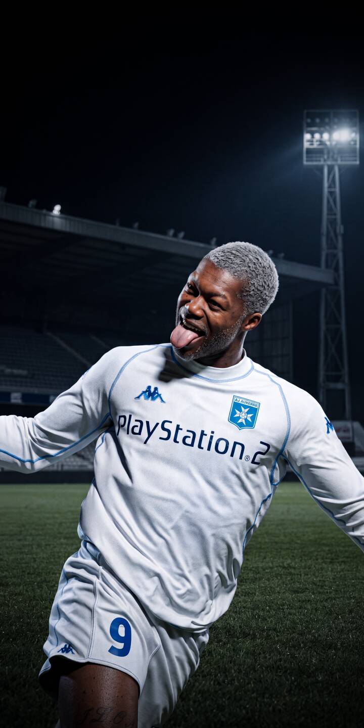 Sticking his tongue out playfully, this energetic footballer with silver hair sports a vintage PlayStation 2 jersey under stadium lights in this fantastic 4K wallpaper. It's a must-have wallpaper for iPhone, capturing a unique moment of fun on the field. | football stadium player iphone retro soccer wallpaper mobile 4k wallpaper hd wallpaper playful playstation2 Sticking his tongue out playfully, this energetic footballer with silver hair sports a vintage PlayStation 2 jersey under stadium lights in this fantastic 4K wallpaper. It's a must-have wallpaper for iPhone, capturing a unique moment of fun on the field.
