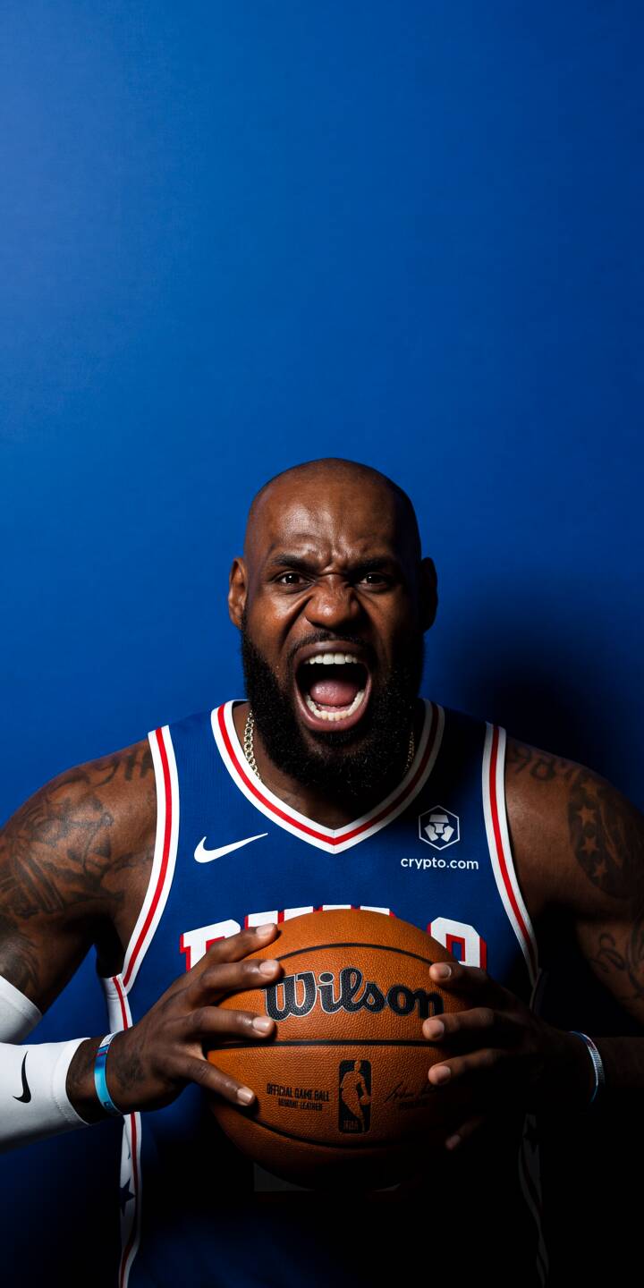 LeBron James unleashes a powerful, open-mouthed roar, gripping a Wilson basketball in this intense 4K wallpaper against a vibrant blue backdrop. This dynamic sports wallpaper is a must-have for iPhone fans, capturing King James's legendary passion. | basketball nba sports lebron james lebron iphone wallpaper mobile 4k wallpaper hd wallpaper king james intense LeBron James unleashes a powerful, open-mouthed roar, gripping a Wilson basketball in this intense 4K wallpaper against a vibrant blue backdrop. This dynamic sports wallpaper is a must-have for iPhone fans, capturing King James's legendary passion.
