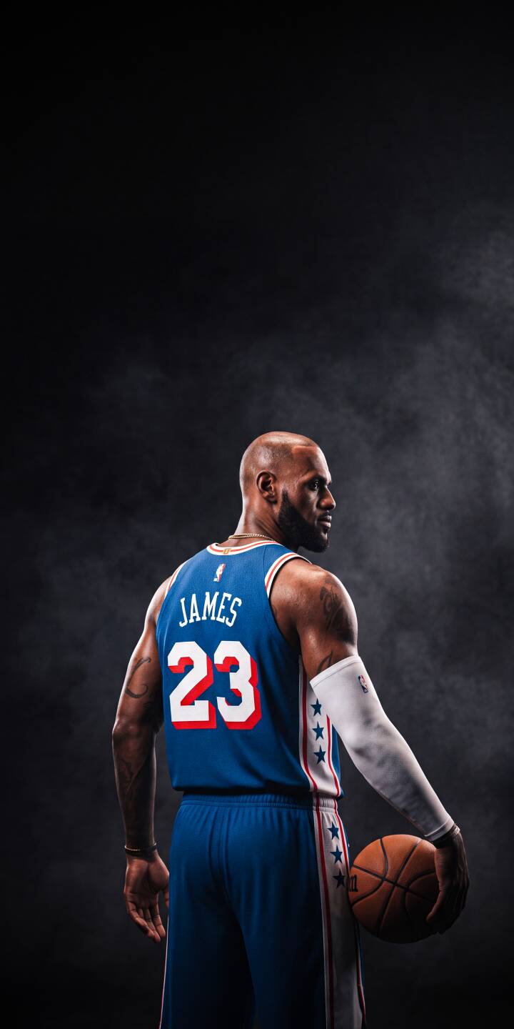 LeBron James, in a vibrant blue jersey, intensely gazes over his shoulder while holding a basketball against a smoky dark backdrop. This powerful 4K wallpaper captures the basketball legend perfectly and is a must-have wallpaper for iPhone users. | basketball nba sports athlete lebron james iphone wallpaper mobile 4k wallpaper hd wallpaper dark background king james LeBron James, in a vibrant blue jersey, intensely gazes over his shoulder while holding a basketball against a smoky dark backdrop. This powerful 4K wallpaper captures the basketball legend perfectly and is a must-have wallpaper for iPhone users.