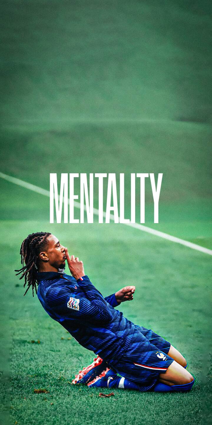 The striking word 'MENTALITY' appears above a confident football player making a shushing gesture on the vibrant green pitch in this dynamic 4K wallpaper. This inspiring wallpaper for iPhone showcases his intense focus and determination. | football athlete iphone france soccer wallpaper mobile mentality 4k wallpaper hd wallpaper dreadlocks shush The striking word 'MENTALITY' appears above a confident football player making a shushing gesture on the vibrant green pitch in this dynamic 4K wallpaper. This inspiring wallpaper for iPhone showcases his intense focus and determination.
