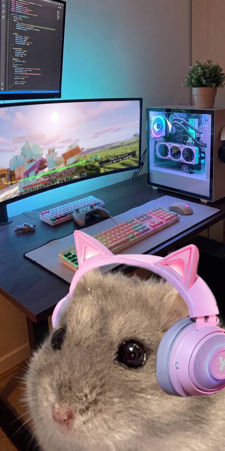 The adorable grey hamster with pink cat-ear headphones captivates the foreground, set against a vibrant RGB gaming setup playing Minecraft in this charming 4K wallpaper for iPhone. This perfect aesthetic wallpaper brings a cozy, gamer vibe to your screen. | aesthetic minecraft iphone wallpaper gamer cat ears mobile hamster 4k wallpaper hd wallpaper gaming setup pink headphones The adorable grey hamster with pink cat-ear headphones captivates the foreground, set against a vibrant RGB gaming setup playing Minecraft in this charming 4K wallpaper for iPhone. This perfect aesthetic wallpaper brings a cozy, gamer vibe to your screen.