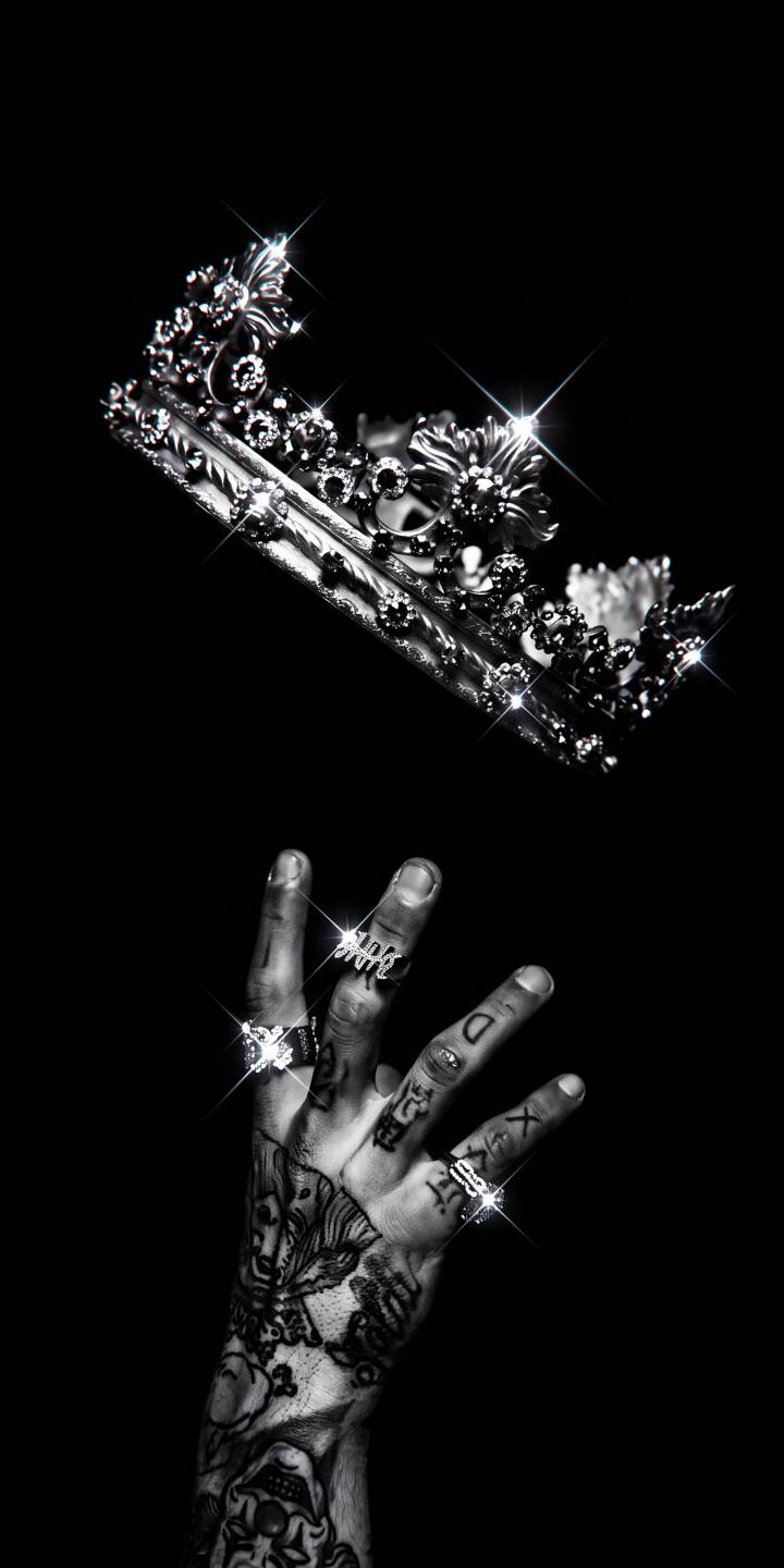 A shimmering, diamond-studded crown descends gracefully towards a heavily tattooed hand adorned with sparkling rings in this striking 4K wallpaper. This captivating monochrome wallpaper is perfect for any iPhone, adding a touch of dark luxury to your screen. | aesthetic hand crown tattoo iphone luxury wallpaper diamonds mobile 4k wallpaper hd wallpaper A shimmering, diamond-studded crown descends gracefully towards a heavily tattooed hand adorned with sparkling rings in this striking 4K wallpaper. This captivating monochrome wallpaper is perfect for any iPhone, adding a touch of dark luxury to your screen.