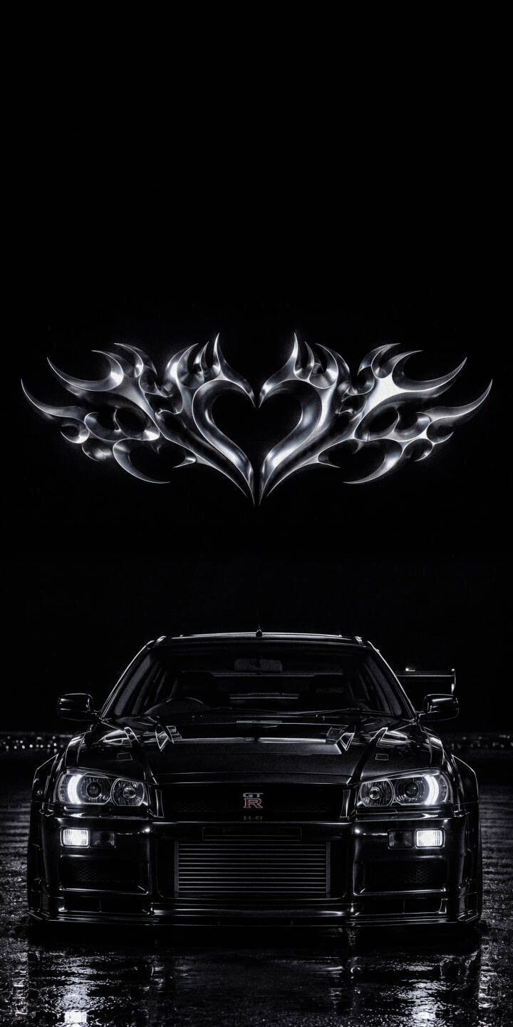 A gleaming chrome tribal heart symbol floats majestically above a sleek, dark Nissan R34 GT-R, its bright headlights casting reflections on the wet ground in this stunning 4K wallpaper; it's a must-have moody automotive wallpaper for iPhone. | aesthetic dark iphone nissan wallpaper mobile 4k wallpaper hd wallpaper automotive gt-r chrome heart r34 skyline A gleaming chrome tribal heart symbol floats majestically above a sleek, dark Nissan R34 GT-R, its bright headlights casting reflections on the wet ground in this stunning 4K wallpaper; it's a must-have moody automotive wallpaper for iPhone.