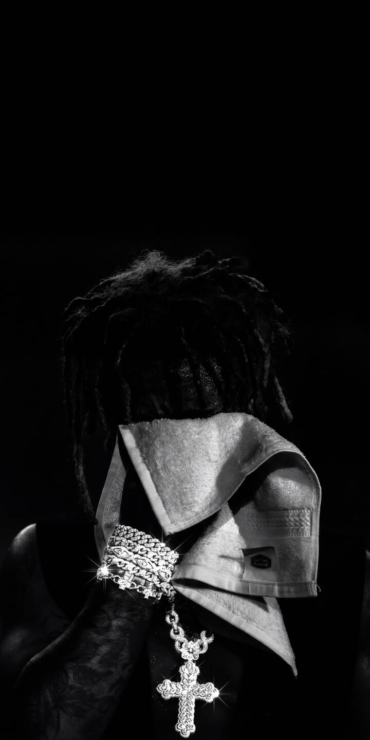 The dazzling glitter of a diamond-studded cross and iced-out bracelet shines against the mysterious dreadlocked figure in this striking black and white 4K wallpaper. This powerful and aesthetic image makes a perfect lock screen wallpaper for iPhone users. | aesthetic rapper artist iphone wallpaper black and white mobile 4k wallpaper hd wallpaper diamond cross dreadlocks bling The dazzling glitter of a diamond-studded cross and iced-out bracelet shines against the mysterious dreadlocked figure in this striking black and white 4K wallpaper. This powerful and aesthetic image makes a perfect lock screen wallpaper for iPhone users.