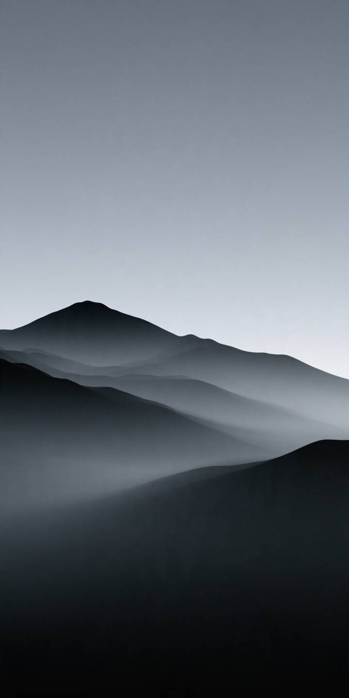Layers of dark mountain silhouettes fade into the soft morning mist beneath a vast, pale gray sky. The subtle monochrome tones and flowing mountain ridges create a peaceful, minimalist landscape, capturing the timeless beauty of silence, solitude, and nature. | nature minimalist mountains mist monochrome Layers of dark mountain silhouettes fade into the soft morning mist beneath a vast, pale gray sky. The subtle monochrome tones and flowing mountain ridges create a peaceful, minimalist landscape, capturing the timeless beauty of silence, solitude, and nature.
