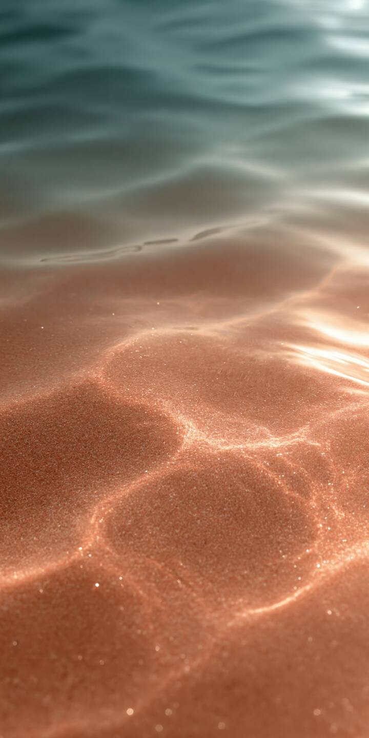 Crystal-clear turquoise water gently flows over a warm, peach-colored sandy seabed, creating delicate golden patterns beneath the sunlight. Soft ripples and shimmering reflections dance across the smooth sand, blending cool ocean tones with beautiful copper and amber highlights. The dreamy textures, natural lighting, and minimalist composition capture the peaceful beauty of a sunlit shoreline, evoking warmth, tranquility, and the relaxing atmosphere of a perfect summer day. | aesthetic beach ocean minimalist ripples Crystal-clear turquoise water gently flows over a warm, peach-colored sandy seabed, creating delicate golden patterns beneath the sunlight. Soft ripples and shimmering reflections dance across the smooth sand, blending cool ocean tones with beautiful copper and amber highlights. The dreamy textures, natural lighting, and minimalist composition capture the peaceful beauty of a sunlit shoreline, evoking warmth, tranquility, and the relaxing atmosphere of a perfect summer day.