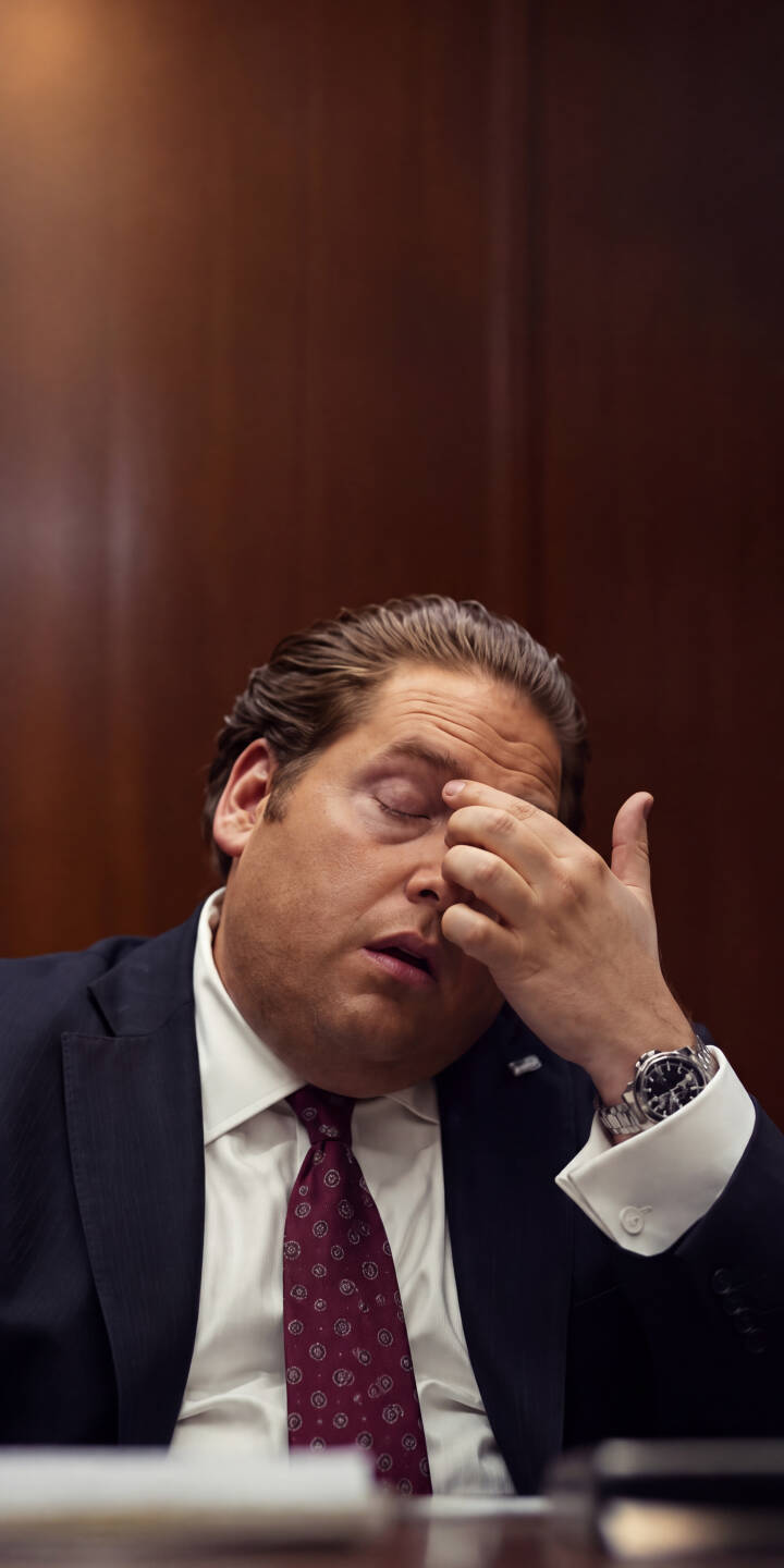 Jonah Hill's weary expression is front and center as he rubs his temple, captured in exquisite 4K detail, making this an impactful wallpaper for iPhone. This compelling wallpaper depicts a powerful moment of corporate tension, perfect for fans of the actor's intense roles. | actor suit iphone wallpaper drama mobile 4k wallpaper hd wallpaper corporate stressed wolf of wall street jonah hill Jonah Hill's weary expression is front and center as he rubs his temple, captured in exquisite 4K detail, making this an impactful wallpaper for iPhone. This compelling wallpaper depicts a powerful moment of corporate tension, perfect for fans of the actor's intense roles.