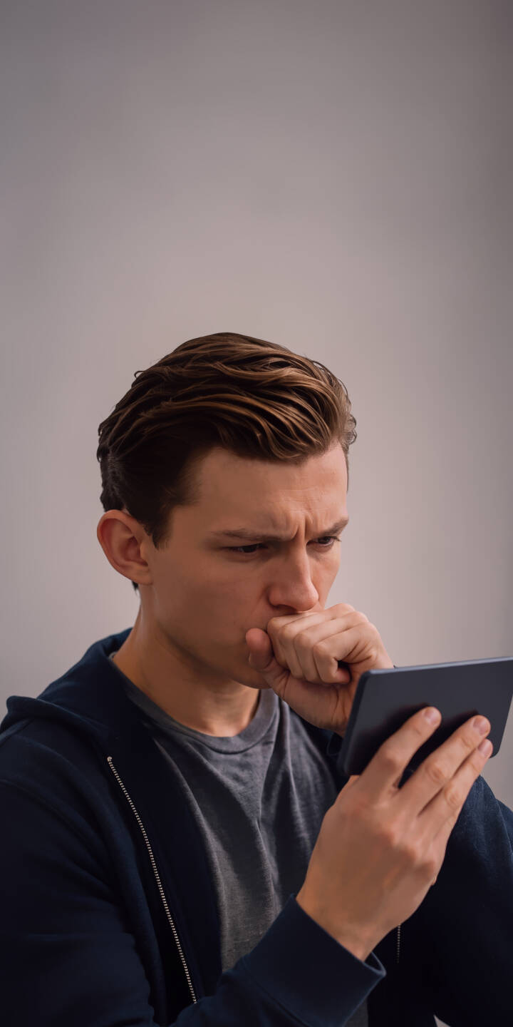 Tom Holland's intensely focused gaze and furrowed brow as he consults his device create a captivating scene in this striking 4K wallpaper. This thought-provoking wallpaper, showcasing the actor's reflective expression, is perfect for any iPhone. | portrait actor spiderman iphone wallpaper mobile 4k wallpaper hd wallpaper device tom holland thoughtful pensive Tom Holland's intensely focused gaze and furrowed brow as he consults his device create a captivating scene in this striking 4K wallpaper. This thought-provoking wallpaper, showcasing the actor's reflective expression, is perfect for any iPhone.