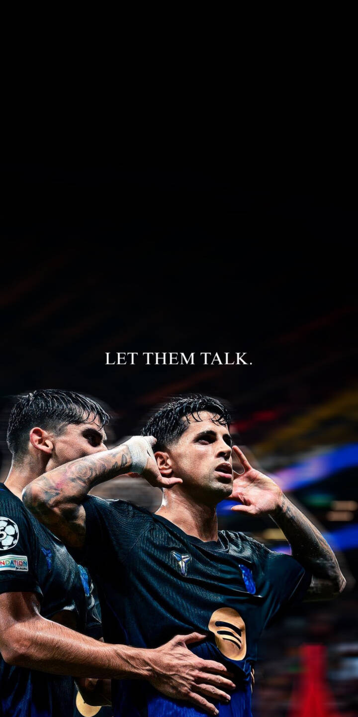The defiant message 'LET THEM TALK.' floats above a triumphant footballer cupping his ear in celebration. This stunning 4K wallpaper captures the player's confidence, wearing his dark jersey with the Spotify logo, perfect as an inspiring wallpaper for your iPhone. | sports celebration iphone soccer wallpaper fc barcelona mobile let them talk footballer 4k wallpaper hd wallpaper victory confident cancelo joao cancelo The defiant message 'LET THEM TALK.' floats above a triumphant footballer cupping his ear in celebration. This stunning 4K wallpaper captures the player's confidence, wearing his dark jersey with the Spotify logo, perfect as an inspiring wallpaper for your iPhone.