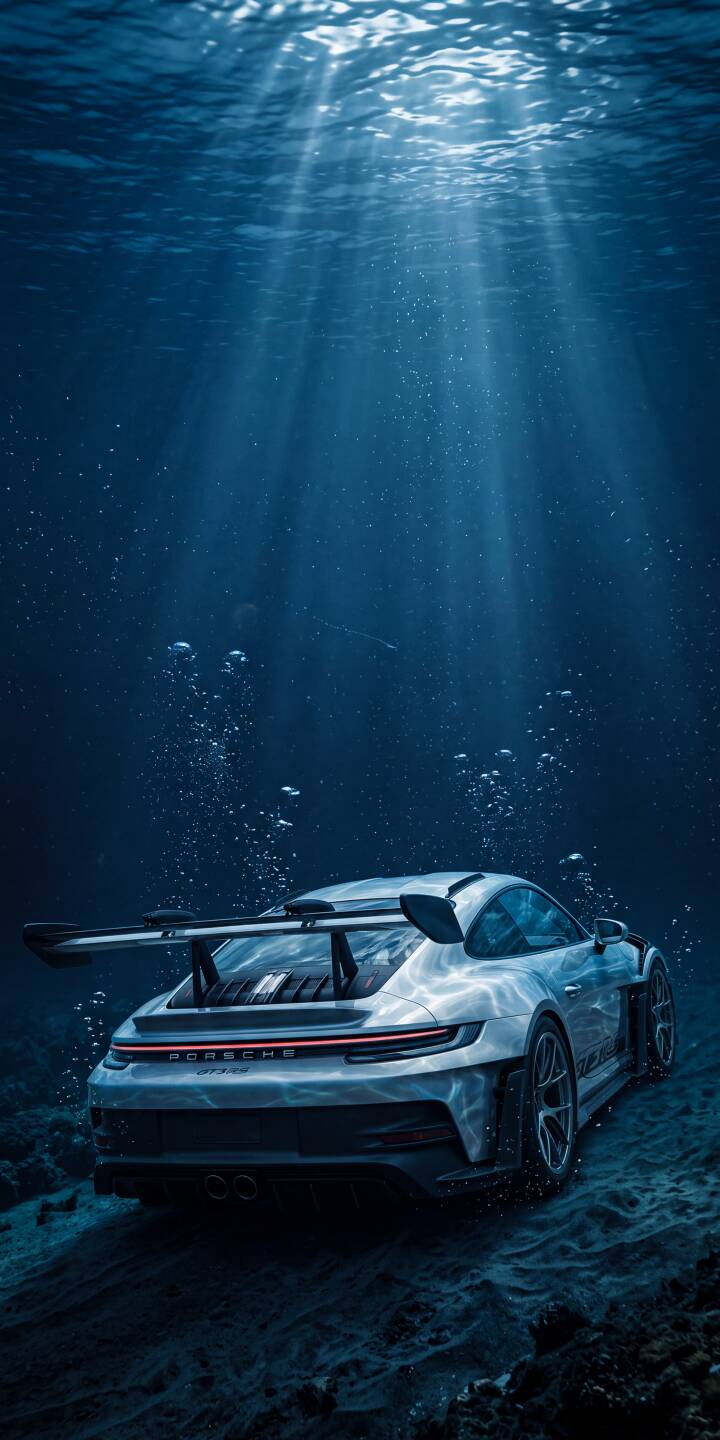 Sunlight streaks dramatically through the deep blue water as a sleek Porsche GT3 rests on the seabed in this breathtaking 4K wallpaper. This stunning underwater scene makes an extraordinary wallpaper for iPhone. | blue car underwater iphone porsche ocean wallpaper mobile porsche 911 4k wallpaper hd wallpaper porsche gt3 Sunlight streaks dramatically through the deep blue water as a sleek Porsche GT3 rests on the seabed in this breathtaking 4K wallpaper. This stunning underwater scene makes an extraordinary wallpaper for iPhone.