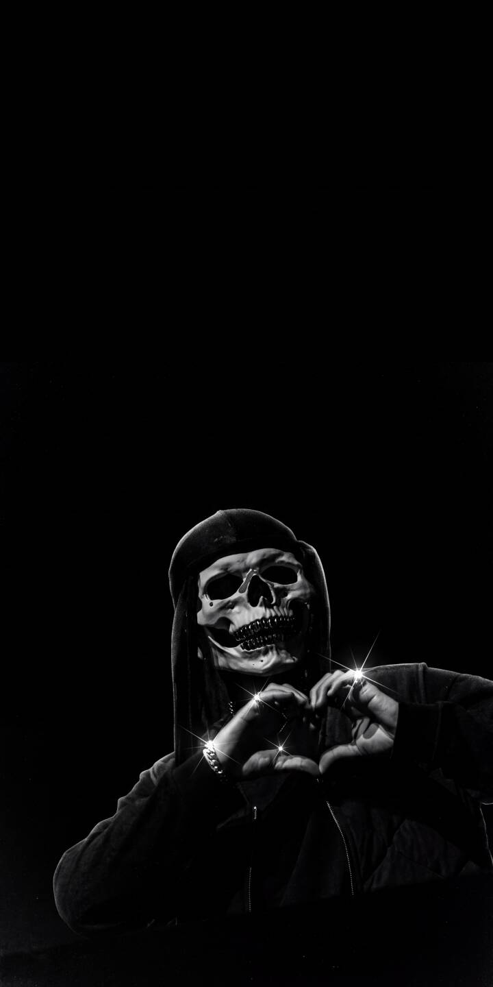 Sparkling rings glint as a mysterious hooded skull figure forms a unique heart shape against a deep black background in this striking 4K wallpaper. This dark and edgy wallpaper is a captivating choice for any iPhone. | aesthetic dark hoodie skeleton heart gothic skull iphone wallpaper mobile 4k wallpaper hd wallpaper Sparkling rings glint as a mysterious hooded skull figure forms a unique heart shape against a deep black background in this striking 4K wallpaper. This dark and edgy wallpaper is a captivating choice for any iPhone.